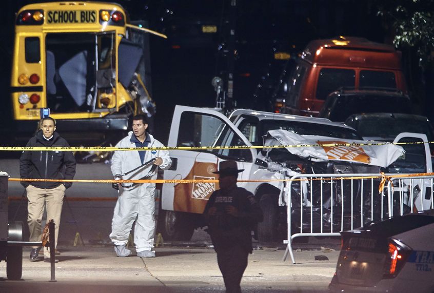 Police work near a damaged Home Depot truck after a motorist drove onto a bike path near the World Trade Center memorial, striking and killing several people, Nov. 1, 2017, in New York. (AP/Andres Kudacki)