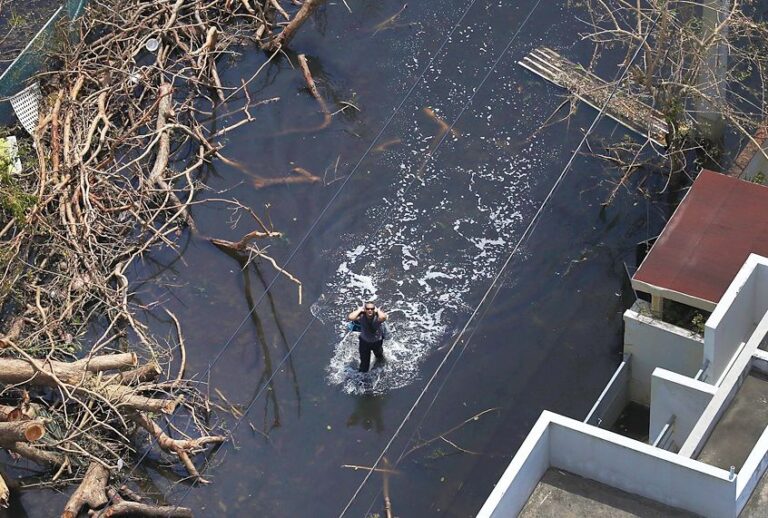 A man stands in a flooded street in the aftermath of Hurricane Maria in San Juan, Puerto Rico (Getty/Joe Raedle)