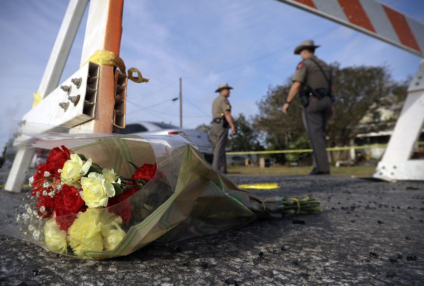 A bouquet of flowers lies at the base of a roadblock at the scene of the shooting at the First Baptist Church of Sutherland Springs, Nov. 6, 2017. (AP/Eric Gay)