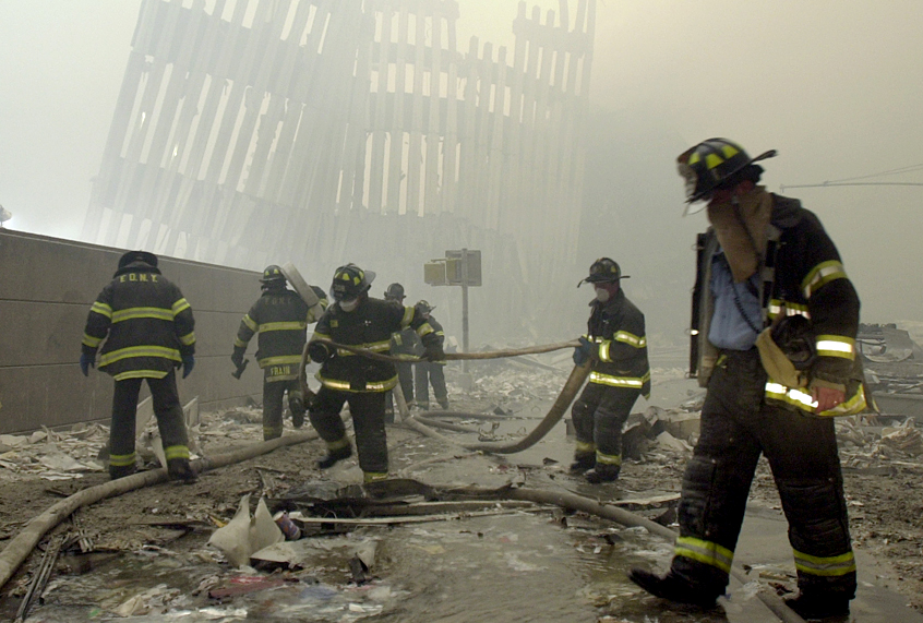 Firefighters work after the terrorist attack on the twin towers of lower Manhattan Tuesday, Sept. 11, 2001 (AP/Mark Lennihan)