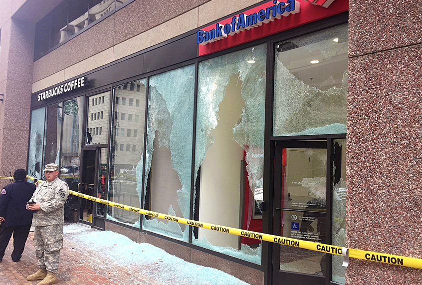 Tape closes off broken windows at businesses in Northwest Washington,  Jan. 20, 2017, after a protestor of Donald Trump's inauguration (AP/Michael Biesecker)
