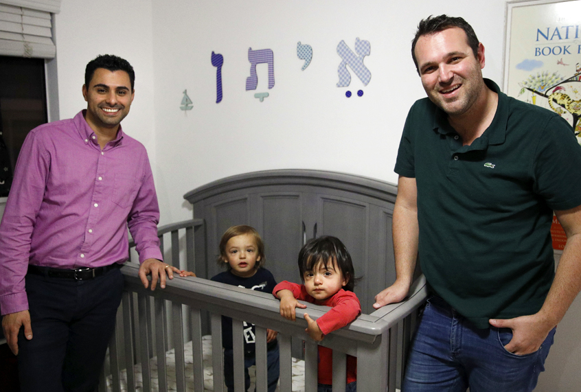 Elad Dvash-Banks, left, and his partner, Andrew, with their twin sons, Ethan, center right, and Aiden. (AP/Jae C. Hong)