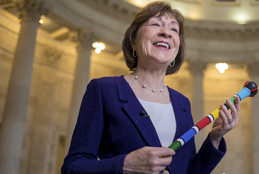 Susan Collins holds a ceremonial "talking stick" (AP/J. Scott Applewhite)