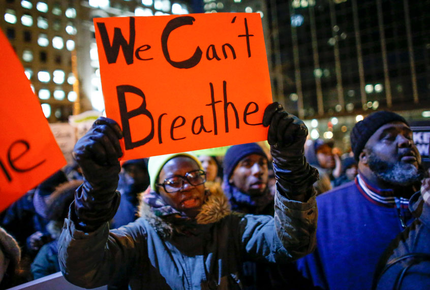 Still from Two Sides trailer, of a woman holding a sign as she takes part in a protest following the death of Eric Garner. (TV One/Getty/Kena Betancur)