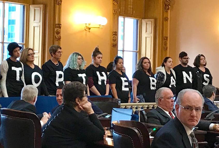 Abortion-rights activists stand in protest after passage of a bill banning abortions in cases of a Down syndrome diagnosis in Ohio (AP/Julie Carr Smyth)