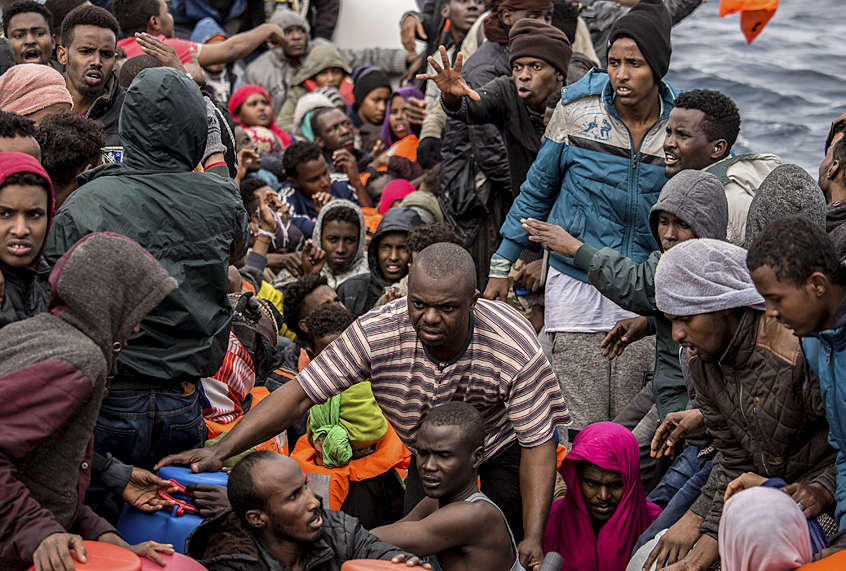 Refugees and migrants wait to be rescued by aid workers of the Spanish NGO Proactiva Open Arms, after leaving Libya trying to reach European soil aboard an overcrowded rubber boat, 60 miles north of Al-Khums, Libya. (AP/Olmo Calvo)