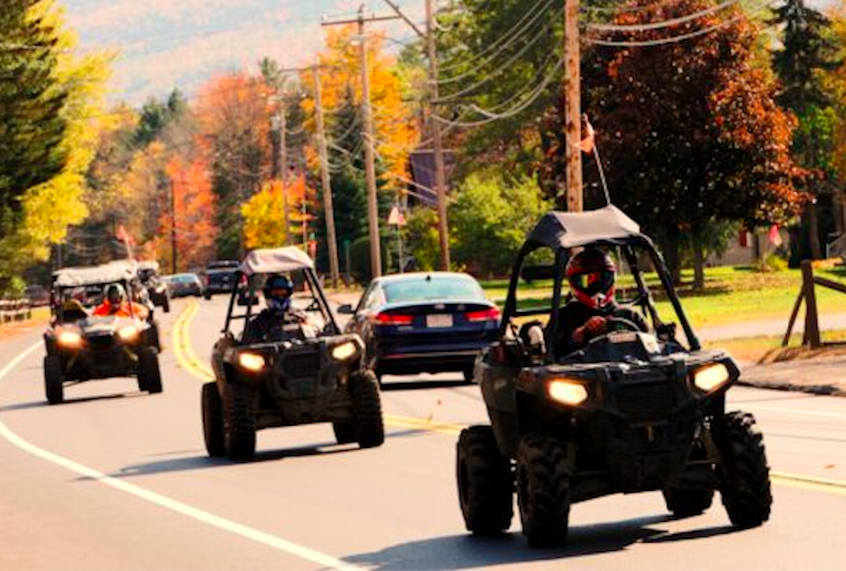 Polaris recreational off-highway vehicles riding on a highway in Gorham, N.H. (Christopher Jensen)
