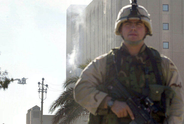 A U.S. Army soldier stands by Iraqi's Oil Ministry after it was hit by missiles, November 21, 2003 in Baghdad, Iraq. (Getty/Joe Raedle)