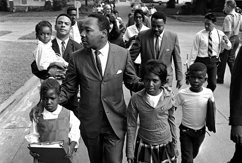 Dr. Martin Luther King Jr. walks between seven-year-old Eva Gracelemon, left, and 10-year-old Aritha Willis as he escorts black school children to formerly all-white schools in Grenada, Miss., Tuesday morning, Sept. 20, 1966. (AP)
