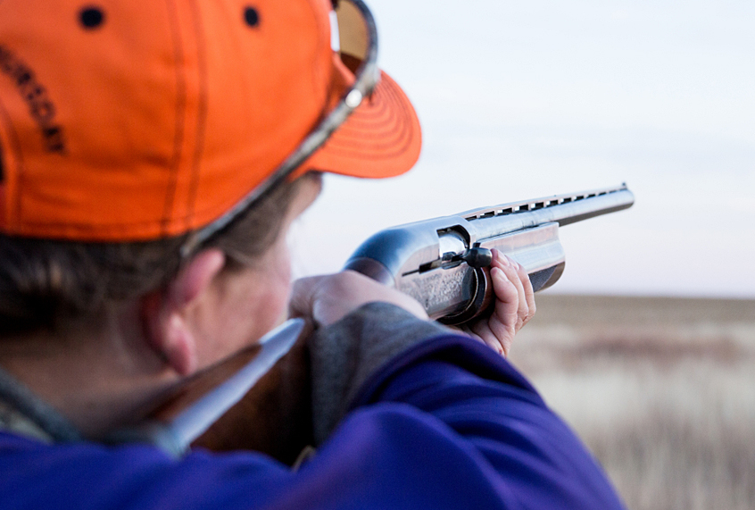 A close up of Ashley Dunham as she lines up her shot for an incoming pheasant on opening day of pheasant season near Hugoton, Kansas. (LaRissa Lawrie)