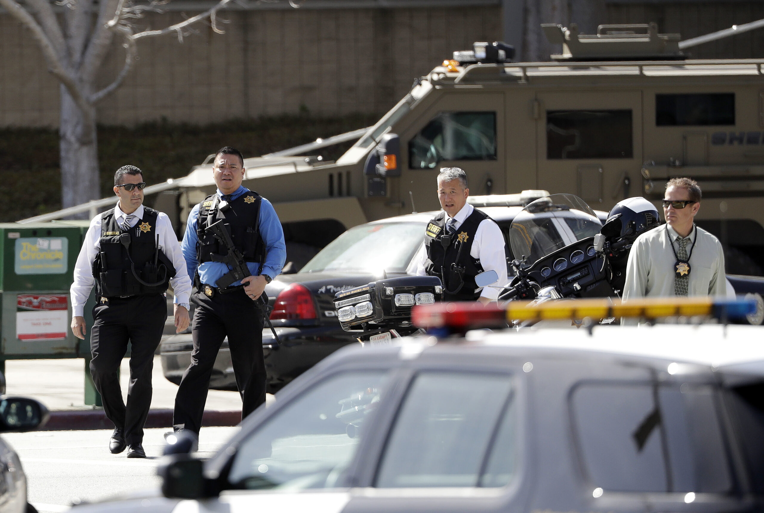 Armed law enforcement personnel exit YouTube headquarters, Tuesday, April 3, 2018, in San Bruno, Calif. (AP Photo/Marcio Jose Sanchez)