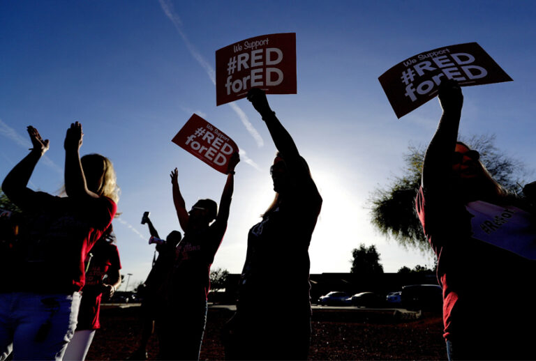 Teachers at Humphrey Elementary school participate in a state-wide walk-in prior to classes Wednesday, April 11, 2018, in Chandler, Ariz. (AP/Matt York)