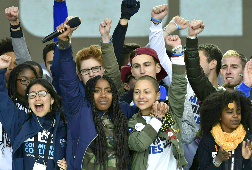 Marjory Stoneman Douglas High School student Emma Gonzalez gathers with other students on stage during the March for Our Lives Rally in Washington, DC on March 24, 2018. (Getty/Nicholas Kamm)