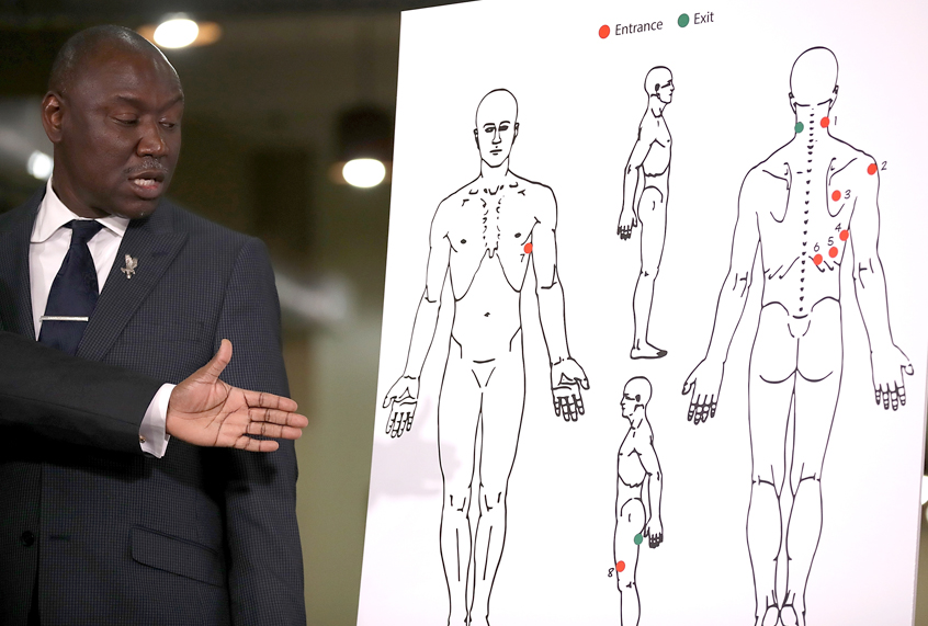 Attorney Ben Crump looks at a diagram showing gunshot wounds to Stephon Clark during a news conference at the Southside Christian Center on March 30, 2018 in Sacramento, California. (Getty/Justin Sullivan)