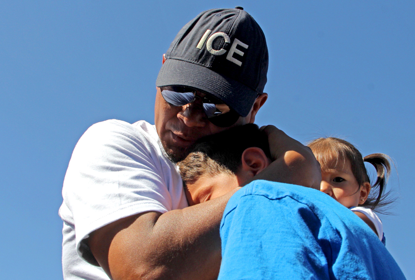 Ivan Castaneda, a former Mexican soldier deported from the United States, embraces his children at the bank of the Rio Grande during the event called "Abrazos No Muros" (Hugs, not walls). (Getty/Herika Martinez)