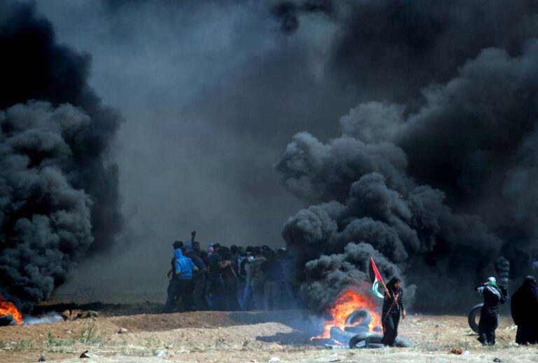 Palestinians clash with Israeli forces near the border between the Gaza strip and Israel, east of Gaza City following the the controversial move to Jerusalem of the United States embassy on May 14, 2018, (Getty/Thomas Coex)
