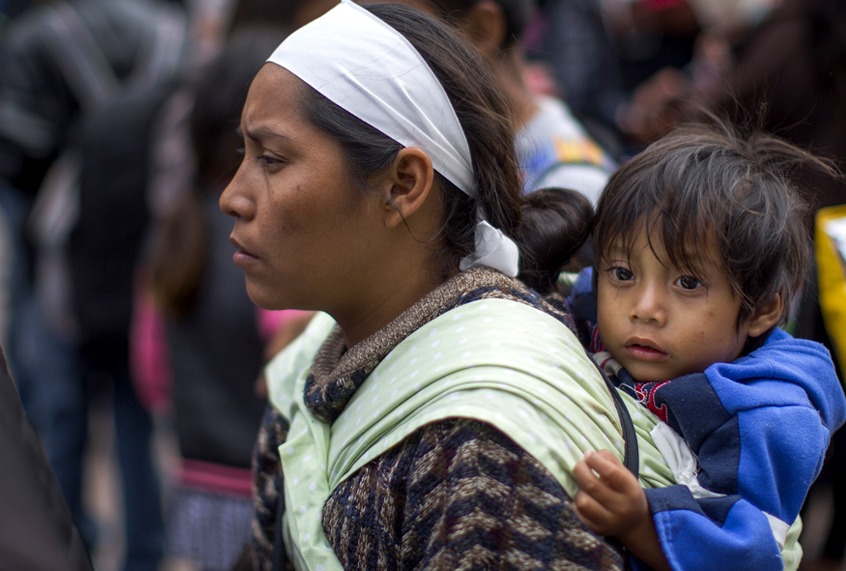Members of a caravan of Central Americans who spent weeks traveling across Mexico walk from Mexico to the U.S. side of the border to ask authorities for asylum. (Getty/David McNew)