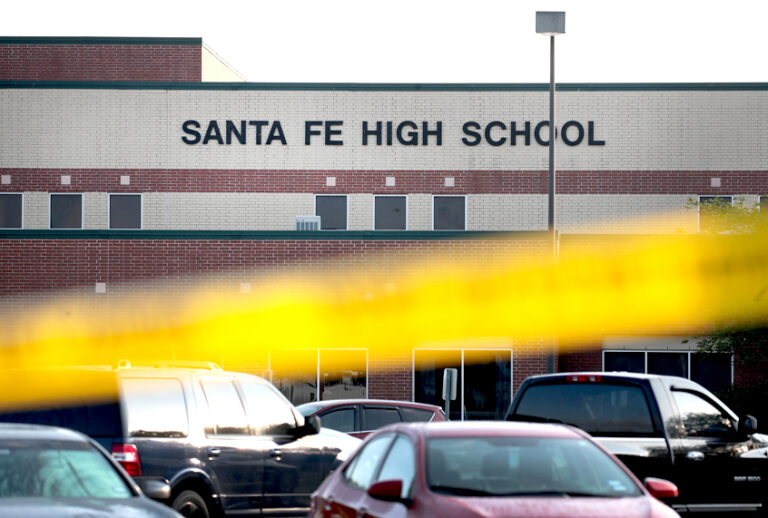 Crime scene tape is stretched across the front of  Santa Fe High School. 17-year-old student Dimitrios Pagourtzis entered the school with a shotgun and a pistol and opened fire, killing at least 10 people. (Getty/Scott Olson)