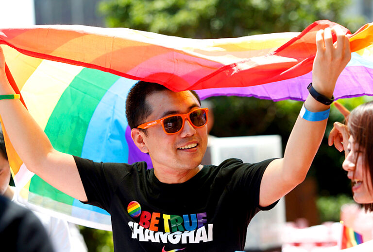 A man holds a rainbow flag after taking part in the Pride Run, part of Shanghai's ninth annual gay-pride festival, in Shanghai on June 17, 2017. (Getty/China OUT)