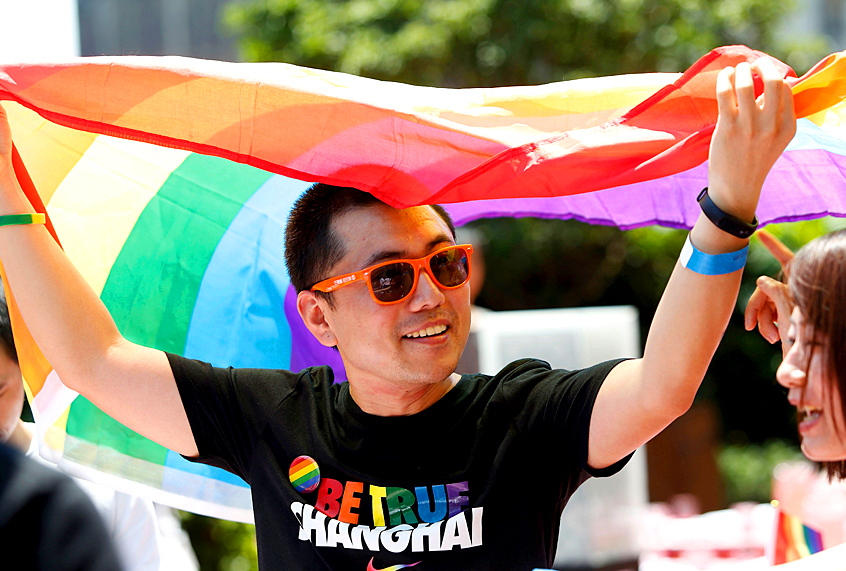 A man holds a rainbow flag after taking part in the Pride Run, part of Shanghai's ninth annual gay-pride festival, in Shanghai on June 17, 2017. (Getty/China OUT)