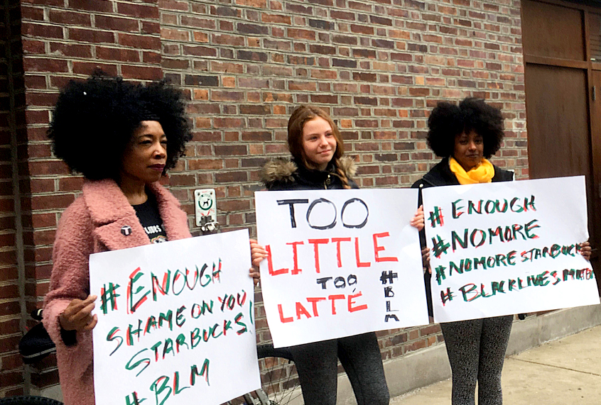 Demonstrators protest outside the Starbucks cafe in Philadelphia where two black men were arrested three days earlier for waiting inside without ordering anything. (AP/Ron Todt)