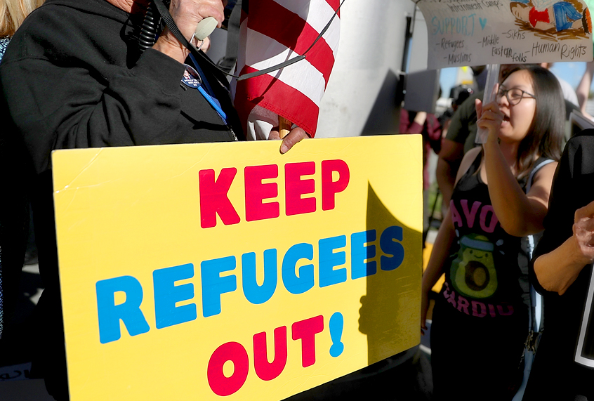 A protester faces off with a supporter of Donald Trump during a demonstration at LAX against the travel ban imposed by Trump. (Getty/Justin Sullivan)