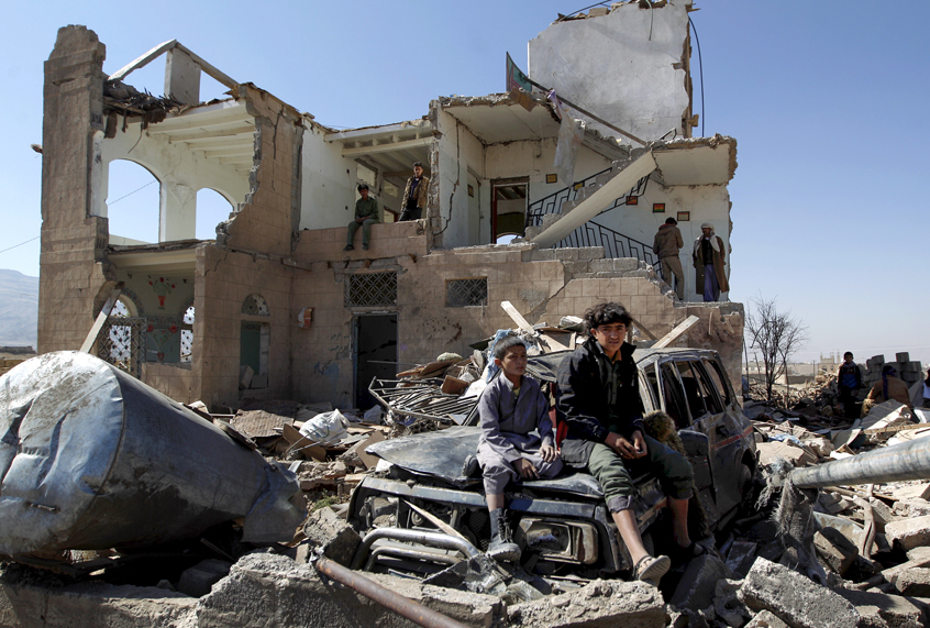 Children sit amidst the rubble of a Saudi-led coalition air strike two days earlier on the outskirts of the Yemeni capital Sanaa on November 14, 2016. (Getty/Mohammed Huwais)