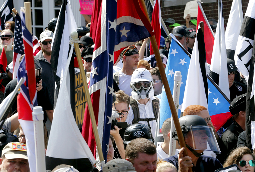 White nationalist demonstrators walk into the entrance of Lee Park surrounded by counter demonstrators in Charlottesville, Va., Saturday, Aug. 12, 2017. (AP/Steve Helber)