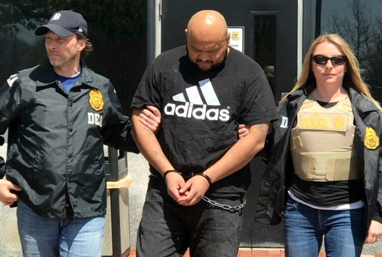 Miguel Angel Corea Diaz, the alleged East Coast leader of MS-13, is lead by Drug Enforcement Administration officers. (AP/Drug Enforcement Administration)