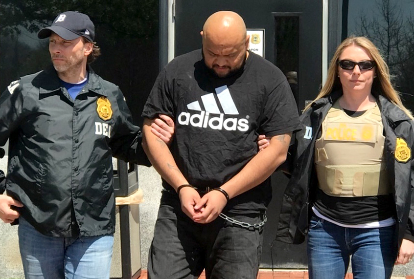 Miguel Angel Corea Diaz, the alleged East Coast leader of MS-13, is lead by Drug Enforcement Administration officers. (AP/Drug Enforcement Administration)