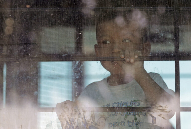 An immigrant child looks out from a U.S. Border Patrol bus, McAllen, Texas, June 23, 2018. (AP/David J. Phillip)