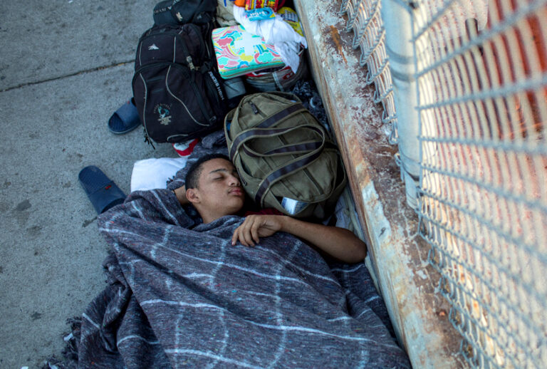 A 14-year-old boy from Honduras sleeps on the Mexican side of the Brownsville & Matamoros International Bridge, where he and his family have been waiting for days after being denied entry into the U.S., near Brownsville, Texas. (Getty/Tamir Kalifa)