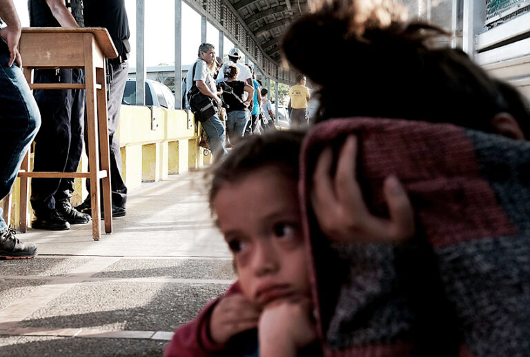 A Honduran child and her mother, fleeing poverty and violence in their home country, as they wait along the border bridge after being denied entry from Mexico into the U.S. (Getty/Spencer Platt)