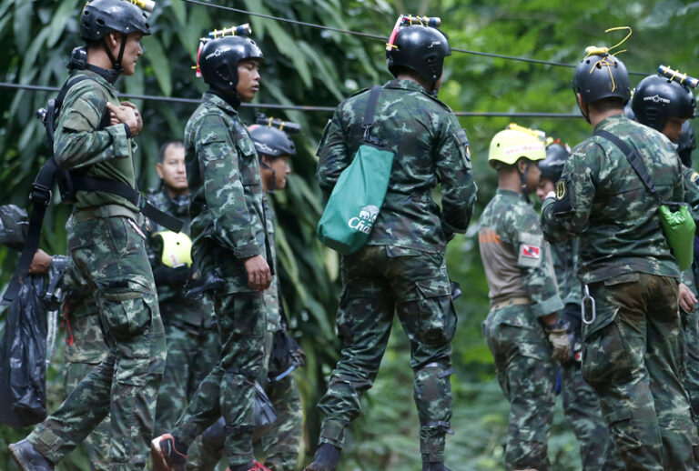 Thai rescuers prepare to enter the cave where 12 boys and their soccer coach have been trapped since June 23, in Mae Sai, Chiang Rai province, in northern Thailand Friday, July 6, 2018. (AP/Sakchai Lalit)
