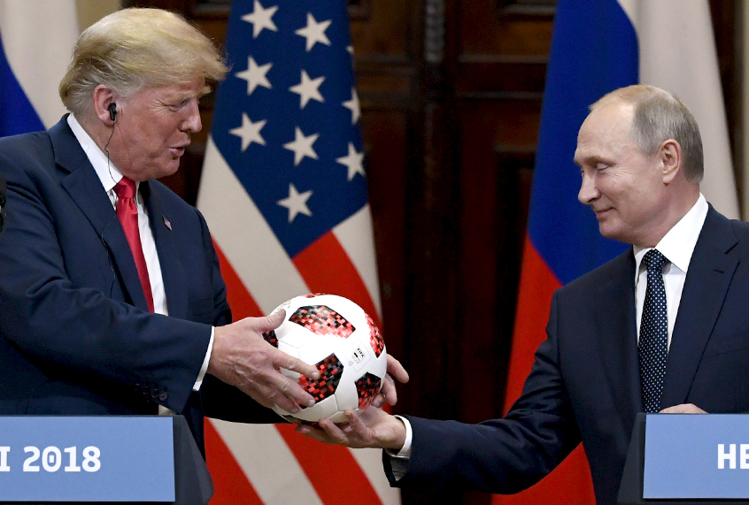 Vladimir Putin presents a soccer ball to Donald Trump during a joint press conference at the Presidential Palace in Helsinki, Finland, Monday, July 16, 2018. (AP/Jussi Nukari/Lehtikuva)