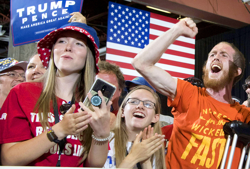 Supporters cheer as Donald Trump arrives to speach during a "Make America Great again" rally. (Getty/Jim Watson)