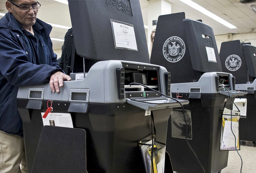 A Board of Elections technician works on a ballot scanning machine at a polling station in Brooklyn, N.Y., Nov. 8, 2016. (AP/Alexander F. Yuan)