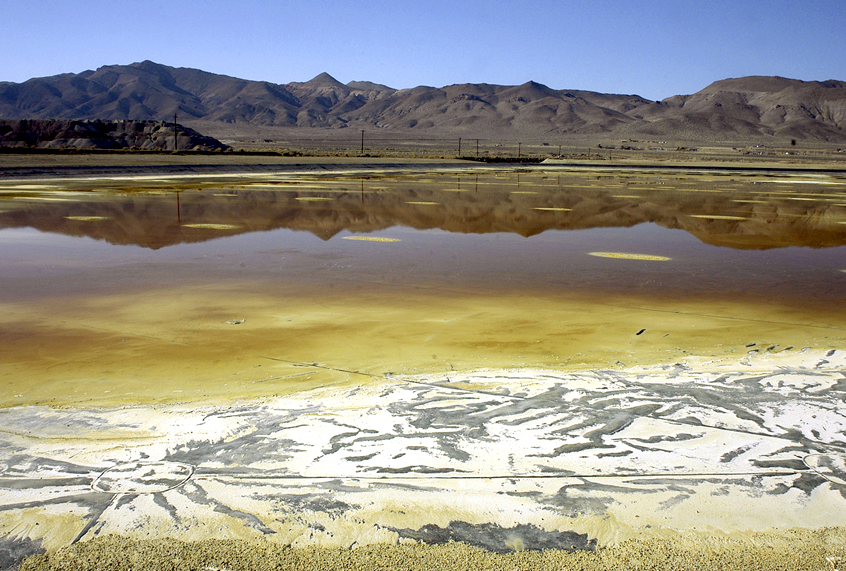 An evaporation pond holds contaminated fluid and sediment at the former Anaconda copper mine near Yerington, Nev. (AP/Debra Reid)