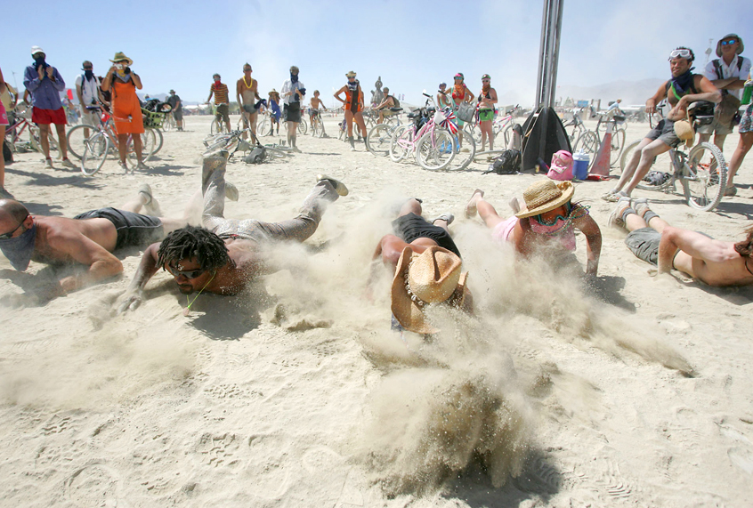 Burning Man participants compete in the swimming leg of the annual Black Rock City triathlon at the Burning Man festival. (AP/Brad Horn)