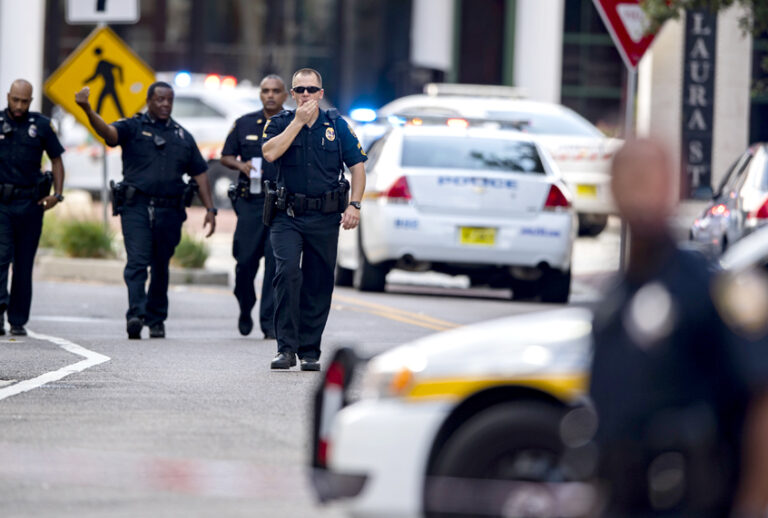 Police gather after a gunman opened fire during an online video game tournament at the Jacksonville Landing in Jacksonville, Fla., Sunday, Aug. 26, 2018. (AP/Laura Heald)