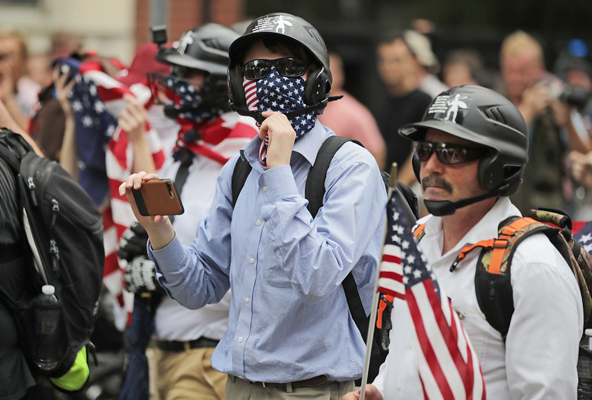 DC Metro Police form a protective phalanx around participants in the Unite the Right rally as they march to the White House, August 12, 2018. (Getty/Chip Somodevilla)
