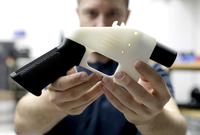 Cody Wilson holds a 3D-printed gun called the Liberator at his shop in Austin, Texas. (AP/Eric Gay)
