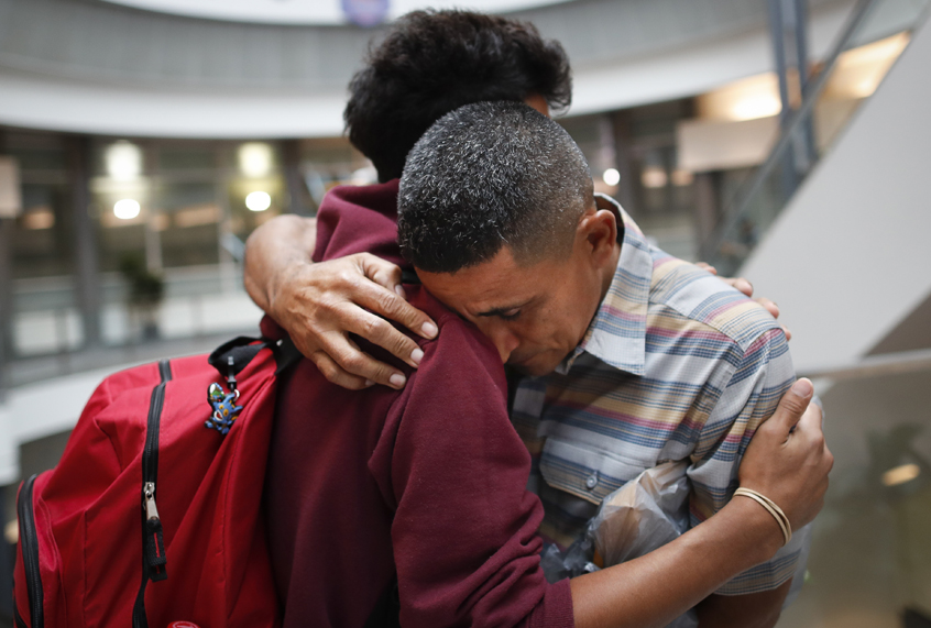 Edvin Cazun, of Guatemala, right, hugs his son Samuel as they reunite after being separated about a month, July 23, 2018, in Hebron, Ky. (AP/John Minchillo)
