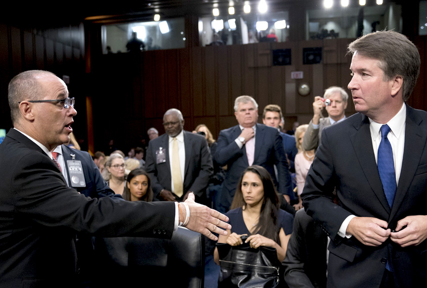 Fred Guttenberg, the father of Jamie Guttenberg who was killed in the Stoneman Douglas High School shooting, attempts to shake hands with Supreme Court nominee, Brett Kavanaugh, as he leaves for a lunch break while appearing before the Senate Judiciary Committee on Capitol Hill in Washington, Sept. 4, 2018. (AP/Andrew Harnik)