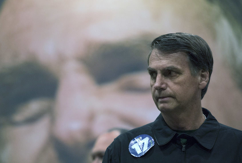 Presidential frontrunner Jair Bolsonaro, of the Social Liberal Party arrives to a press conference in Rio de Janeiro, Brazil, Thursday, Oct. 11, 2018. (AP Photo/Leo Correa) (AP)