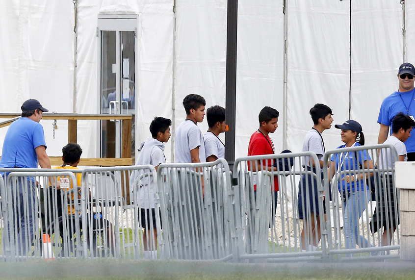 Immigrant children walk in outside the Homestead Temporary Shelter for Unaccompanied Children in Homestead, Fla. (AP/Brynn Anderson)