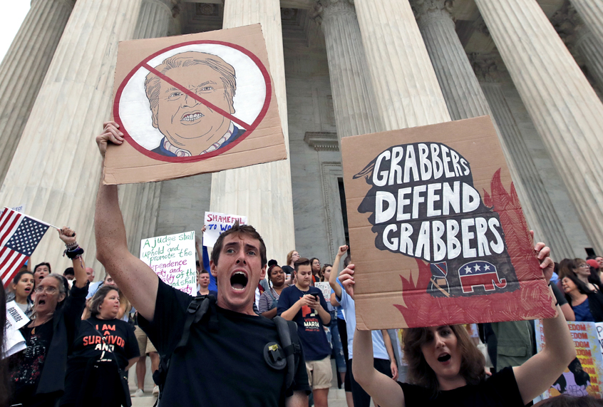 People protest on the steps of the Supreme Court after the confirmation vote of Supreme Court nominee Brett Kavanaugh, on Capitol Hill, Oct. 6, 2018 in Washington. (AP/Alex Brandon)