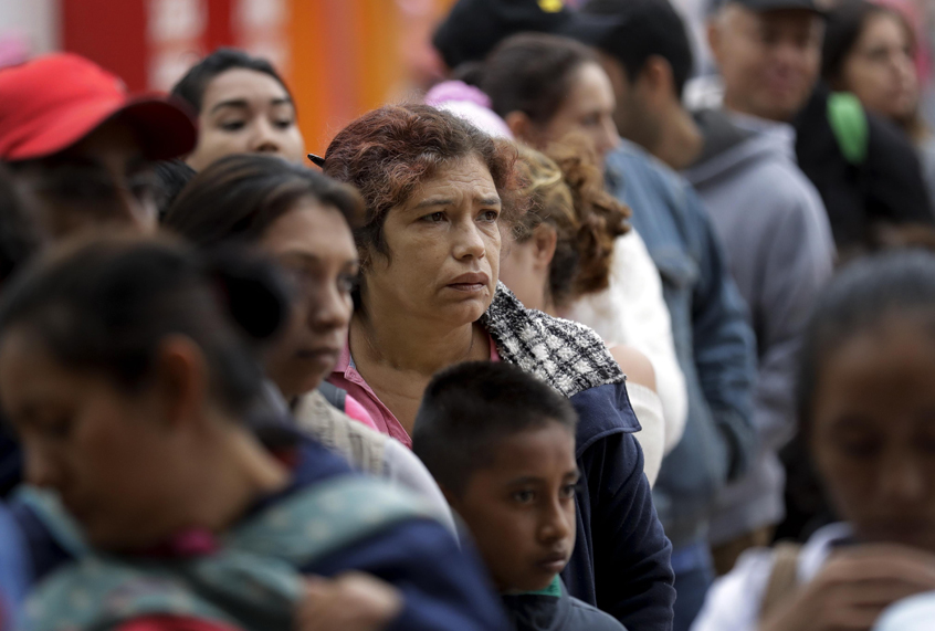 In this Oct. 23, 2018 image, people seeking asylum in the United States line up to receive a number at the border in Tijuana, Mexico. The first obstacle that migrants in a giant caravan may face if they reach the U.S. border is a long wait in Mexico. To enter through San Diego, the wait in Mexico is a month or longer. (AP/Gregory Bull)