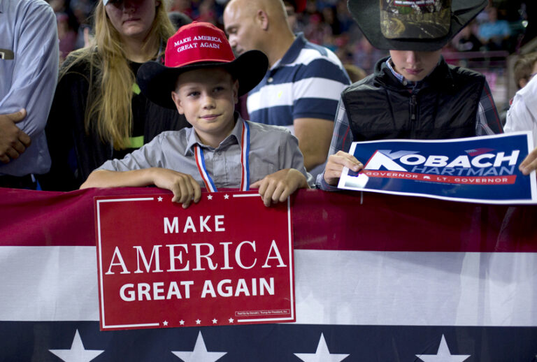 Two young supporters hold campaign signs as they wait to hear President Donald Trump speak at a campaign rally at Kansas Expocentre, Oct. 6, 2018 in Topeka, Kan. (AP/Pablo Martinez Monsivais)