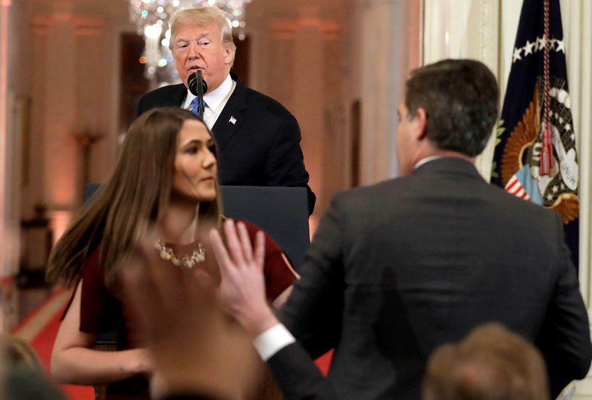 A White House aide takes the microphone from CNN's Jim Acosta, during a news conference in the East Room of the White House, Wednesday, Nov. 7, 2018. A doctored video of this incident went viral. (AP/Evan Vucci)